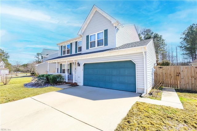 traditional-style home with a garage, concrete driveway, a front lawn, and fence