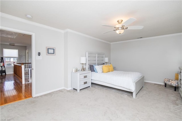 bedroom with attic access, crown molding, and baseboards