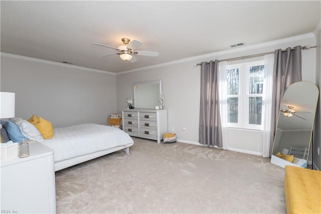 bedroom with crown molding, visible vents, carpet flooring, ceiling fan, and baseboards