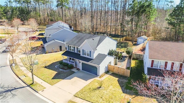 birds eye view of property featuring a view of trees