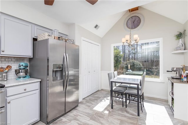 kitchen with vaulted ceiling with beams, decorative backsplash, visible vents, and stainless steel fridge with ice dispenser