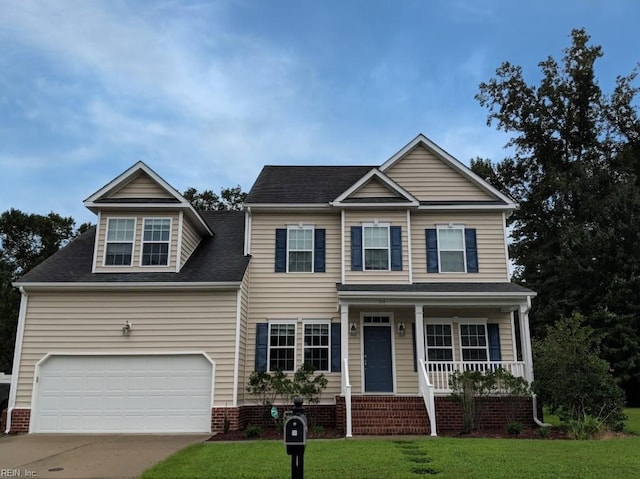 view of front of home featuring a garage, concrete driveway, a front yard, a porch, and brick siding