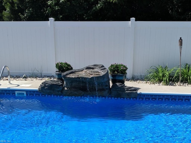 view of swimming pool featuring a fenced in pool and fence