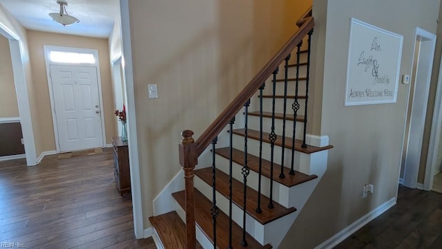 stairway with wood-type flooring and baseboards