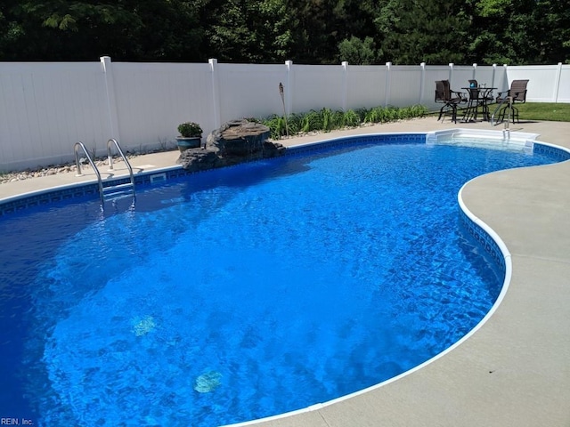 view of pool featuring a patio area, a fenced backyard, and a fenced in pool