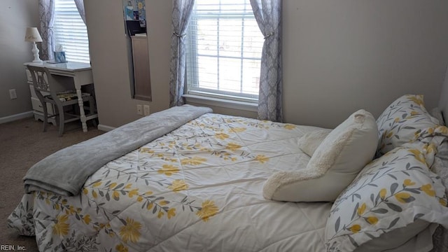 carpeted bedroom featuring baseboards