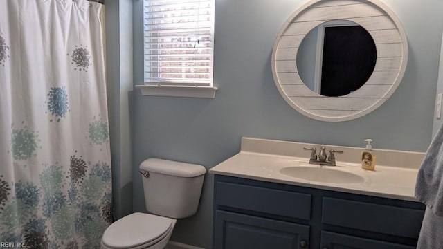 full bath with curtained shower, vanity, and toilet