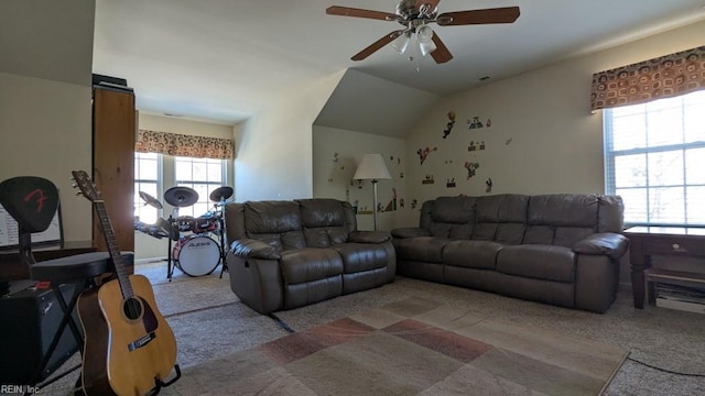 carpeted living room with a ceiling fan, a healthy amount of sunlight, and vaulted ceiling