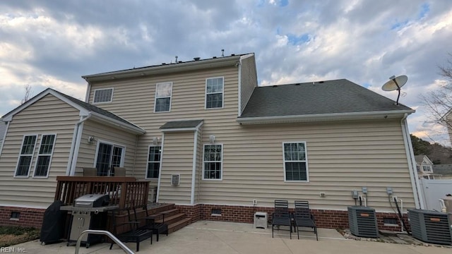 back of property with cooling unit, crawl space, and a patio area