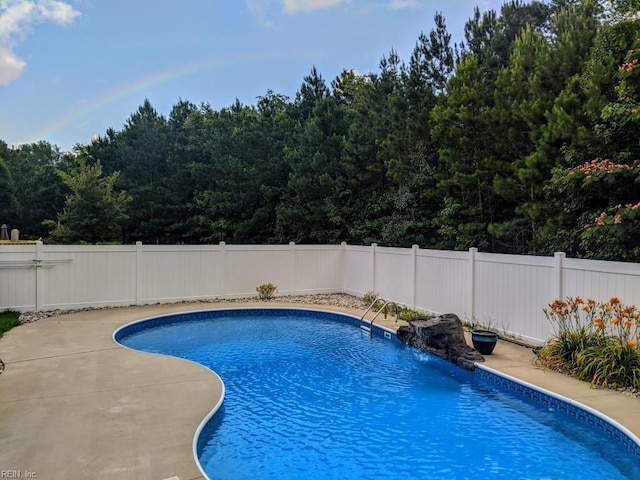 view of pool with a fenced backyard, a fenced in pool, and a patio