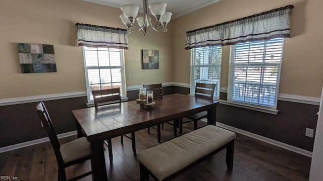 dining area featuring a chandelier, wood-type flooring, and baseboards