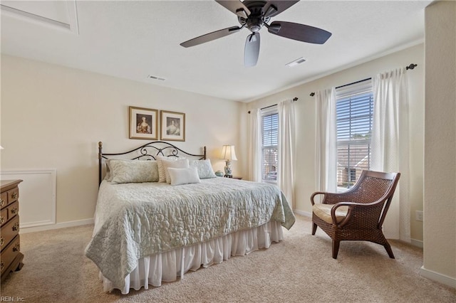 carpeted bedroom with baseboards, visible vents, and a ceiling fan