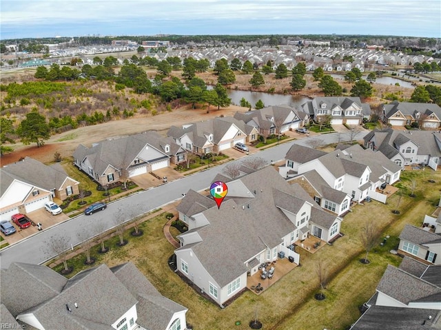 drone / aerial view featuring a water view and a residential view