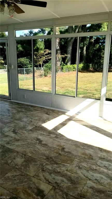 unfurnished sunroom with a ceiling fan