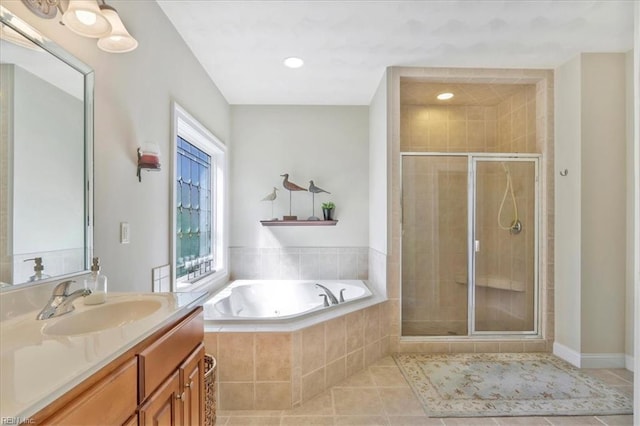 bathroom featuring vanity, a shower stall, a bath, and tile patterned floors