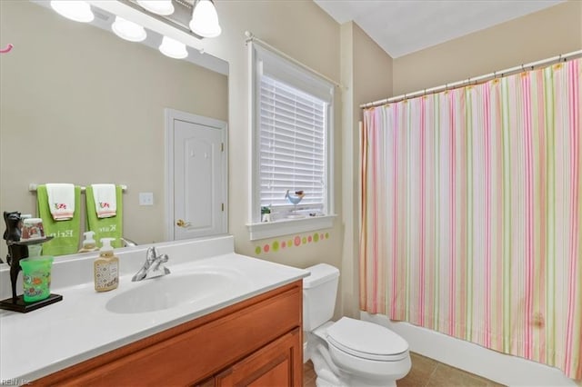 bathroom featuring vanity, toilet, and tile patterned flooring