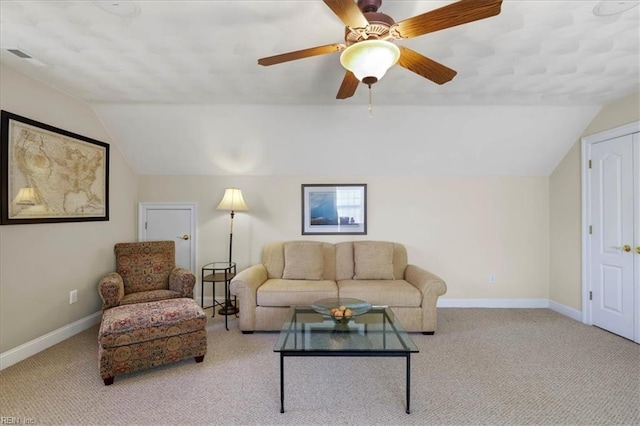 living room featuring baseboards, lofted ceiling, and carpet flooring