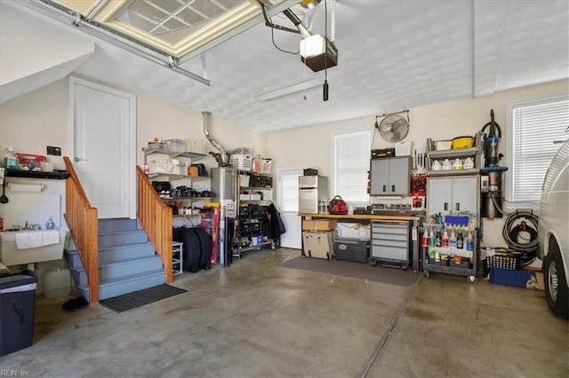 garage featuring a workshop area and a garage door opener