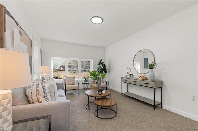 carpeted living area with baseboards