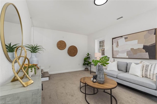 carpeted living room featuring visible vents and baseboards