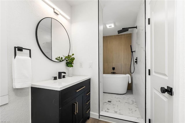 full bathroom with a shower, a freestanding tub, and vanity