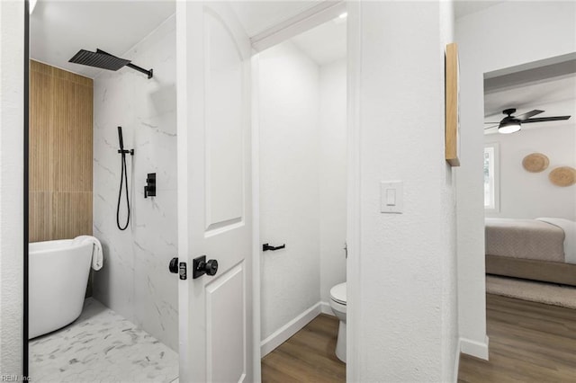 ensuite bathroom featuring a marble finish shower, toilet, ceiling fan, wood finished floors, and ensuite bathroom