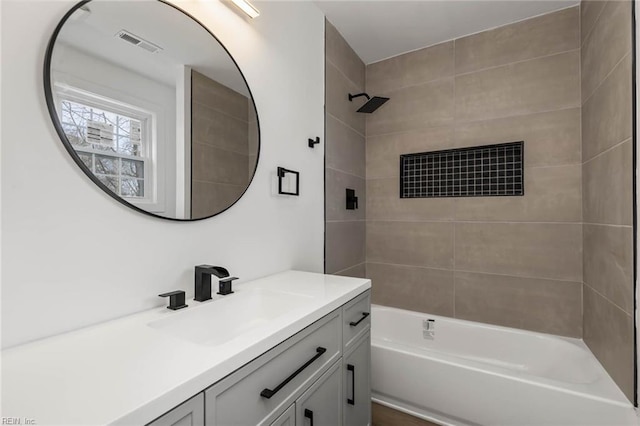 full bath featuring vanity, shower / tub combination, and visible vents