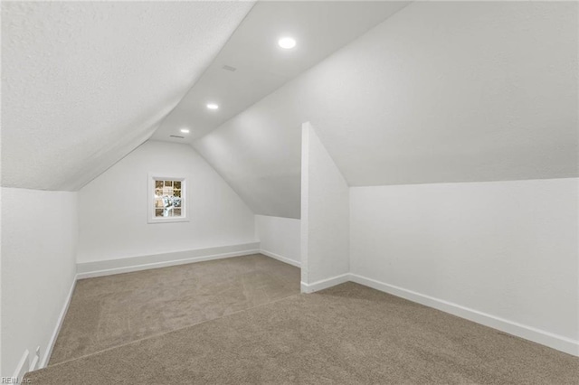 bonus room featuring carpet, lofted ceiling, recessed lighting, a textured ceiling, and baseboards