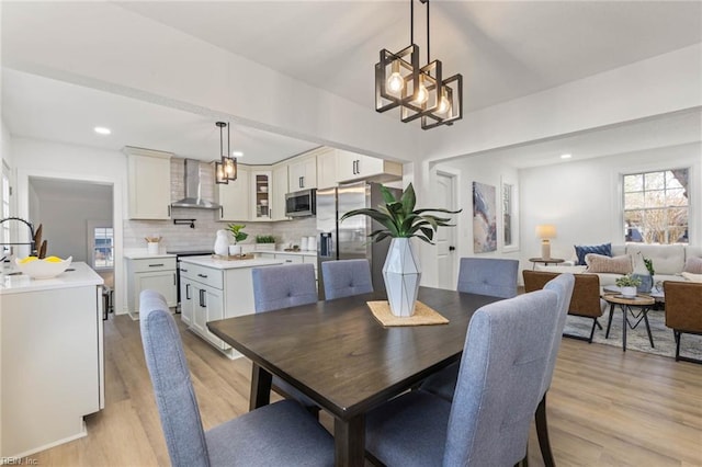 dining room featuring light wood-type flooring and recessed lighting