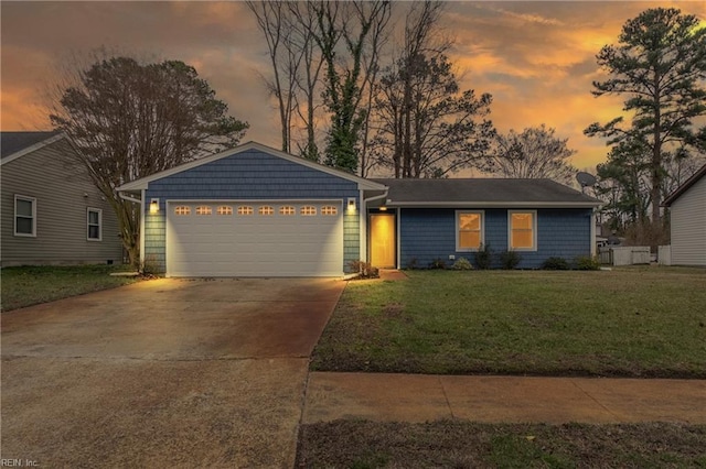 ranch-style house with a front yard, driveway, and an attached garage