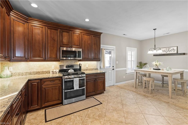 kitchen featuring light tile patterned floors, light stone countertops, stainless steel appliances, and tasteful backsplash