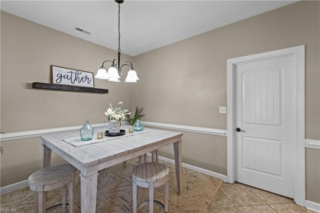 dining space featuring an inviting chandelier, light tile patterned floors, baseboards, and visible vents