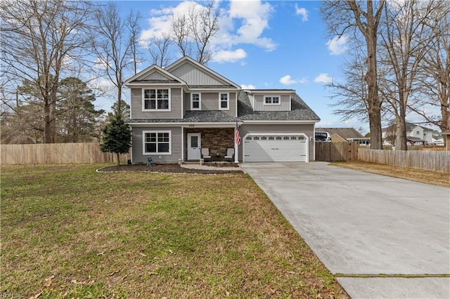 view of front of property featuring a garage, a front yard, driveway, and fence