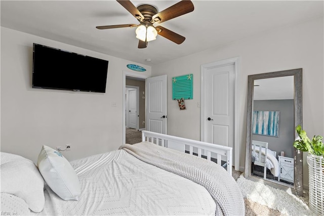 bedroom with light colored carpet, baseboards, and a ceiling fan