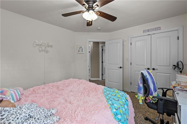 carpeted bedroom with a closet, baseboards, and ceiling fan