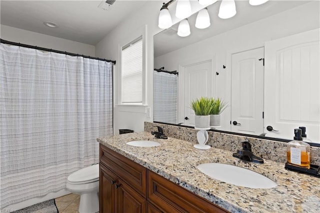 full bath featuring tile patterned flooring, double vanity, toilet, and a sink