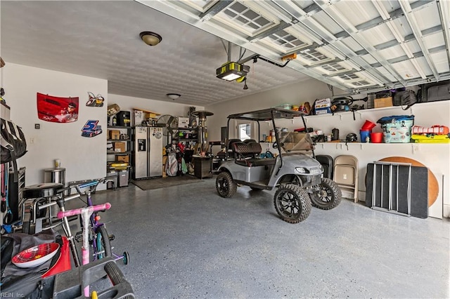 garage featuring a garage door opener and stainless steel fridge