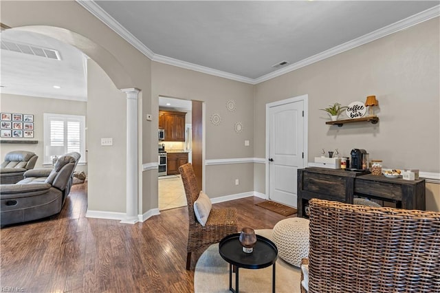 interior space featuring arched walkways, visible vents, wood finished floors, and decorative columns