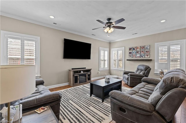 living room featuring visible vents, crown molding, ceiling fan, baseboards, and recessed lighting