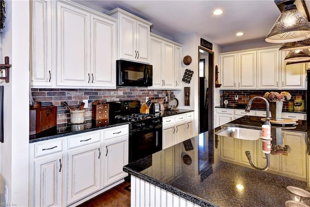 kitchen featuring decorative backsplash, black appliances, white cabinetry, a sink, and recessed lighting