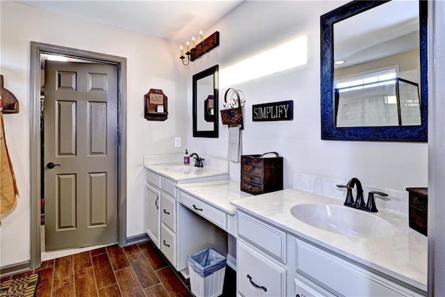 full bathroom featuring double vanity, a sink, and wood finish floors