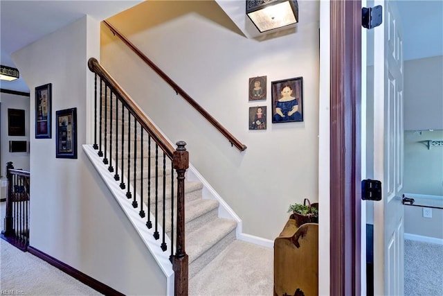 staircase with carpet floors and baseboards