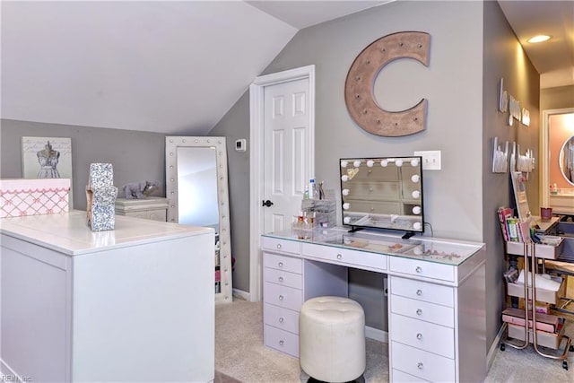 bathroom featuring lofted ceiling, washer / dryer, and baseboards