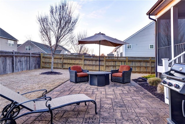 view of patio / terrace with an outdoor fire pit and a fenced backyard