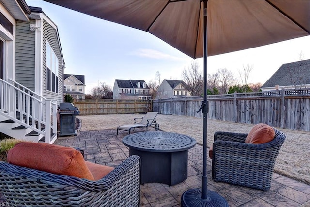 view of patio with a fenced backyard, a residential view, and area for grilling