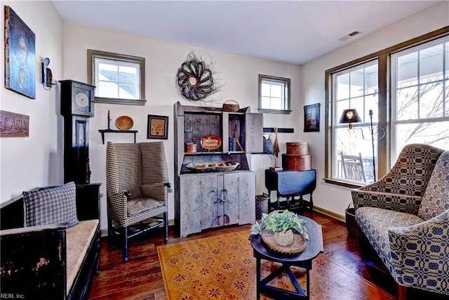 sitting room featuring a healthy amount of sunlight, hardwood / wood-style flooring, baseboards, and visible vents