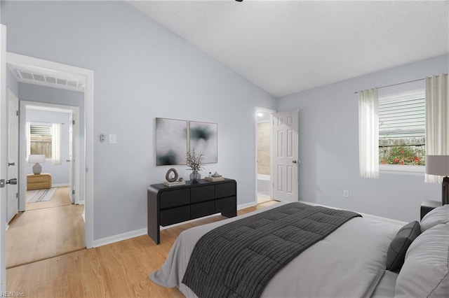 bedroom with high vaulted ceiling, light wood-style flooring, multiple windows, and baseboards