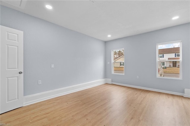 unfurnished room with recessed lighting, baseboards, and wood finished floors