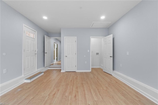 unfurnished bedroom with light wood finished floors, recessed lighting, attic access, and baseboards