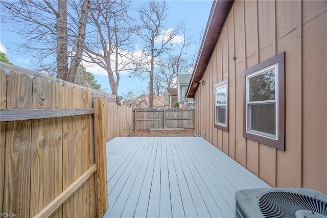 wooden terrace featuring cooling unit and a fenced backyard